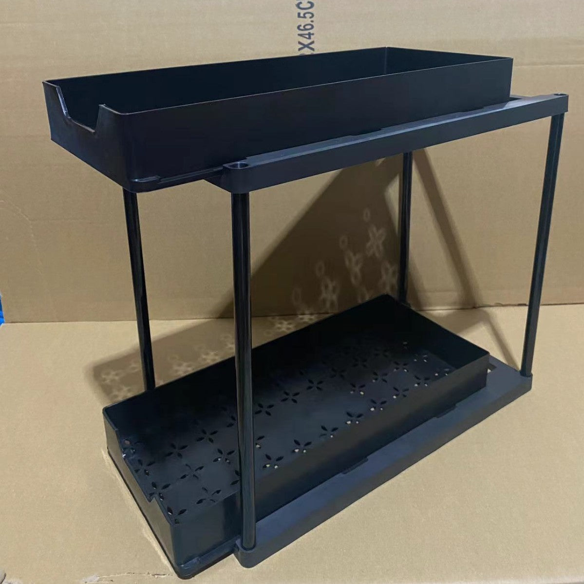 BLACK Two-tier pull-out storage rack. An organizational lifesaver for under the kitchen sink. Features adjustable shelves for easy storage of bottles and jars. In a sleek, modern design. Perfect as a kitchen shelf, bathroom organizer, or household storage