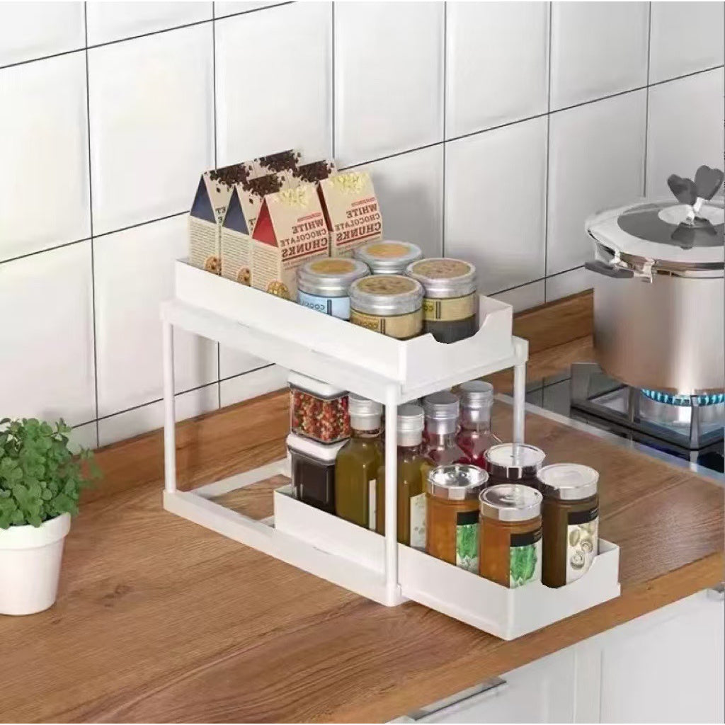 Two-tier pull-out storage rack. An organizational lifesaver for under the kitchen sink. Features adjustable shelves for easy storage of bottles and jars. In a sleek, modern design. Perfect as a kitchen shelf, bathroom organizer, or household storage(WHITE